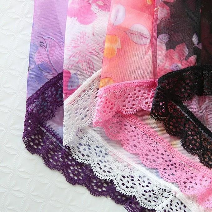 Close-up of colorful fabric with lace trim on a white background