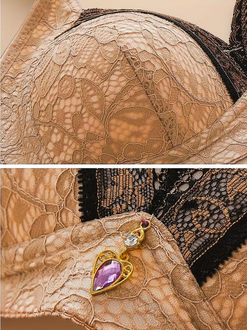 Close-up of lace fabric with a decorative charm featuring a purple gemstone.