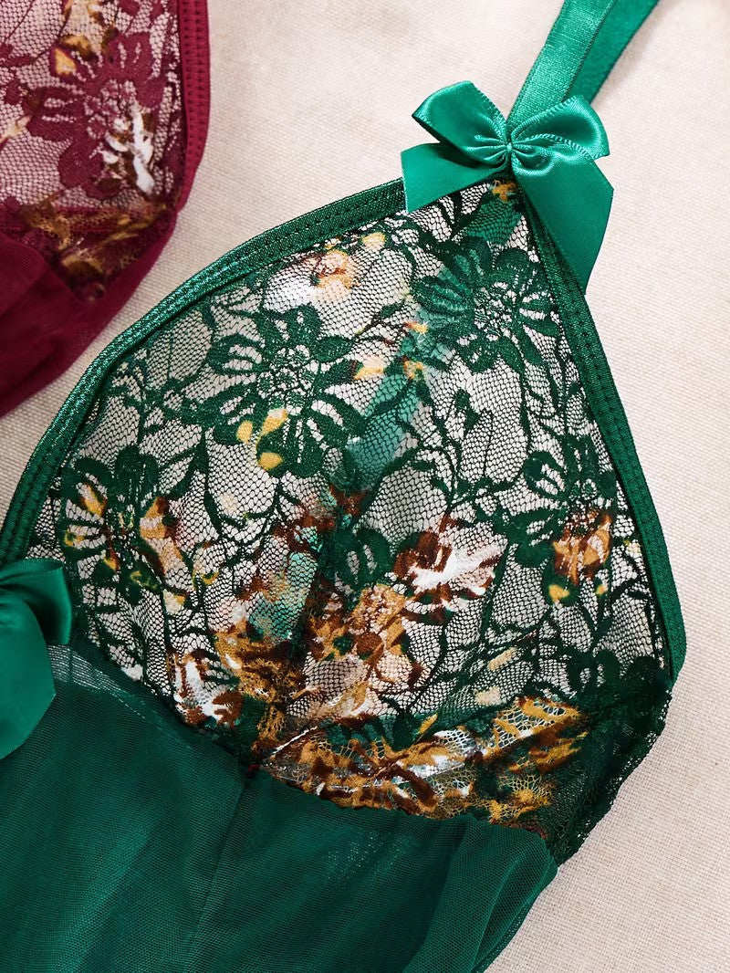 Green lace bra with floral patterns and a bow on a beige background