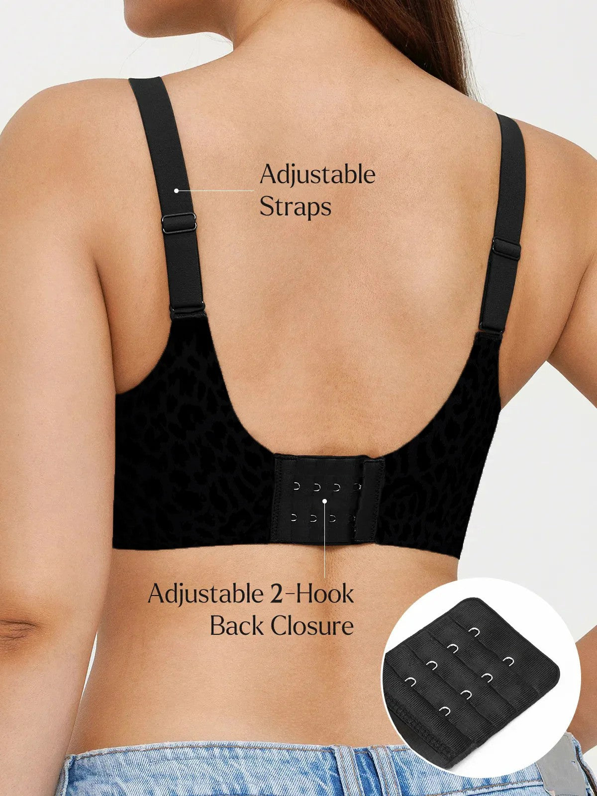 Black compression garment with adjustable straps and back closure on a person wearing jeans.