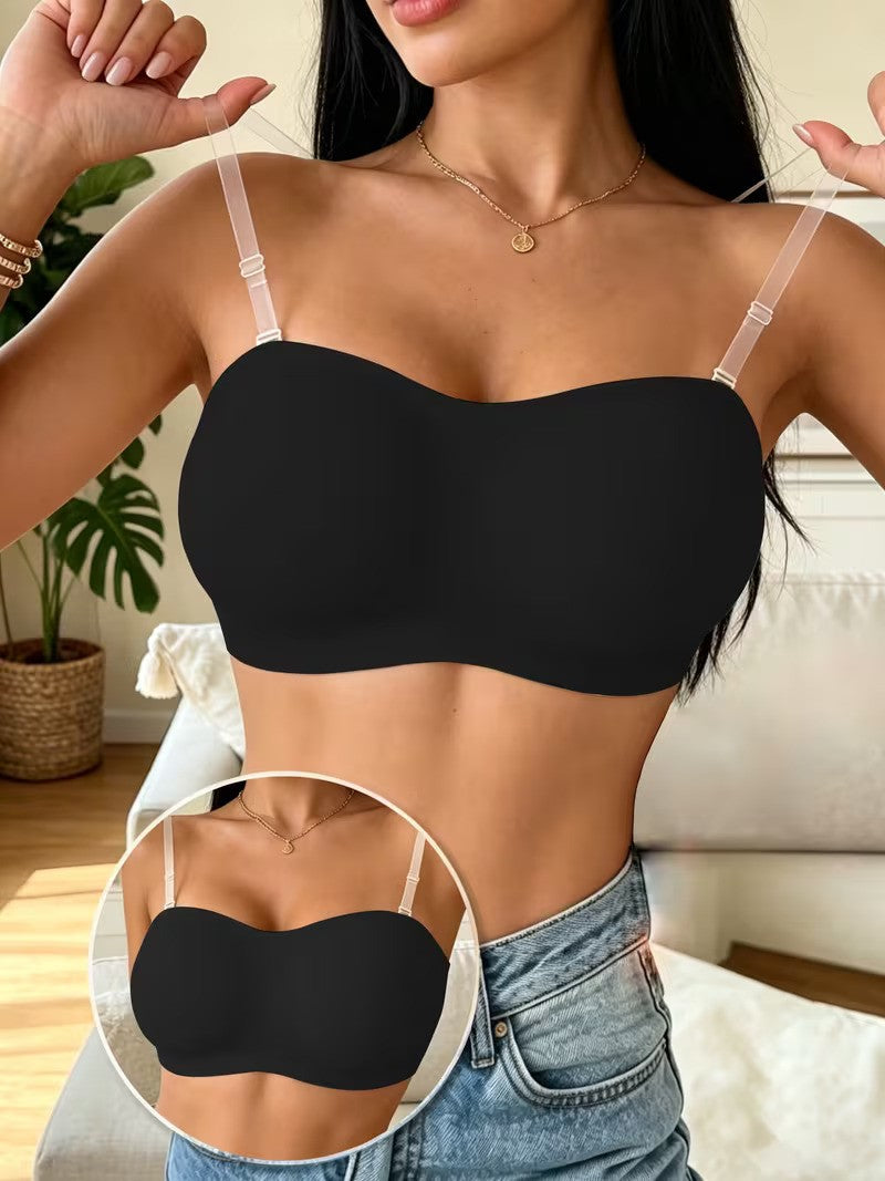 Woman wearing a black strapless bra with a close-up inset, standing in a home setting.