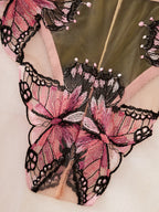 Close-up of a sheer pink mesh lingerie bottom with large embroidered butterfly motifs in pink, black, and white, plus a pale peach lining.