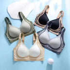 Set of four bras in different colors on a light blue background
