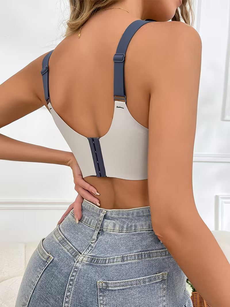 Person wearing a white crop top with blue straps and high-waisted jeans.